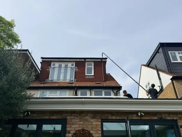 Cleaning a tiled roof and soffits with an extension lance