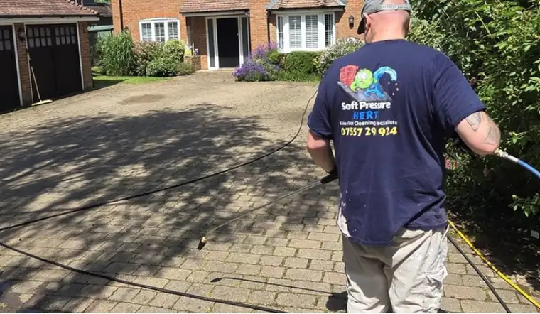 Faded grey block paved driveway before cleaning